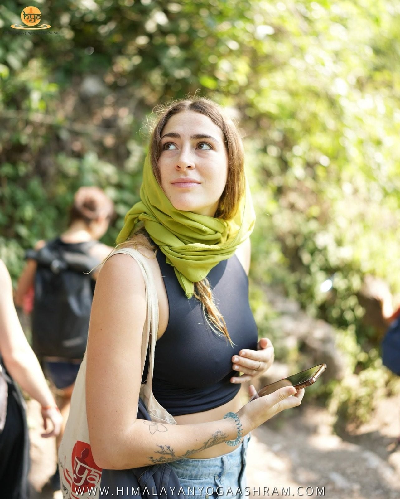 Yoga retreat participant enjoying a reflective moment outdoors in Rishikesh