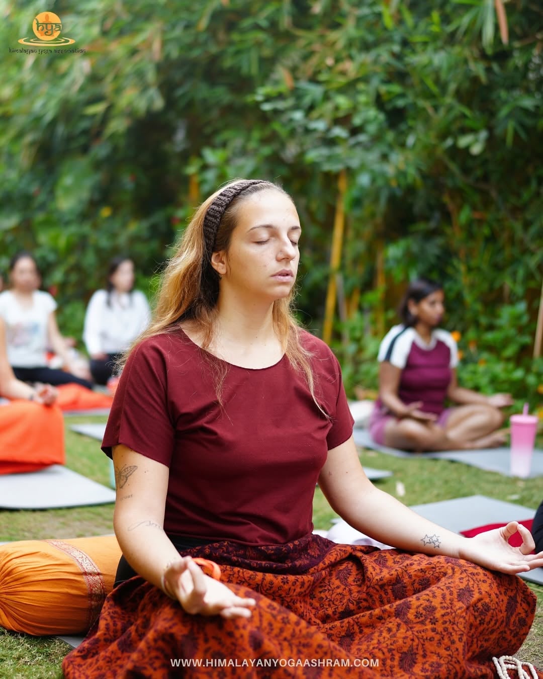 Student meditating on the garden lawn at Himalayan Yoga Ashram