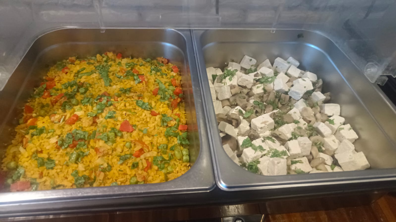 Fresh vegetarian dishes in buffet trays.