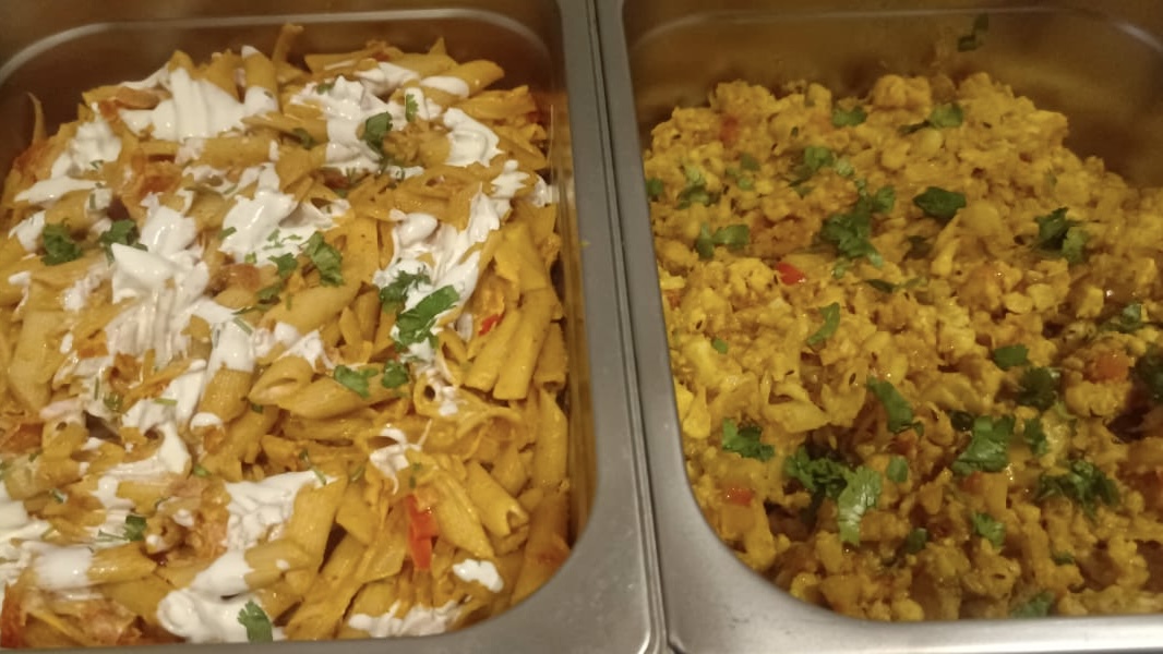 Assorted salads and grains, hygienically served.